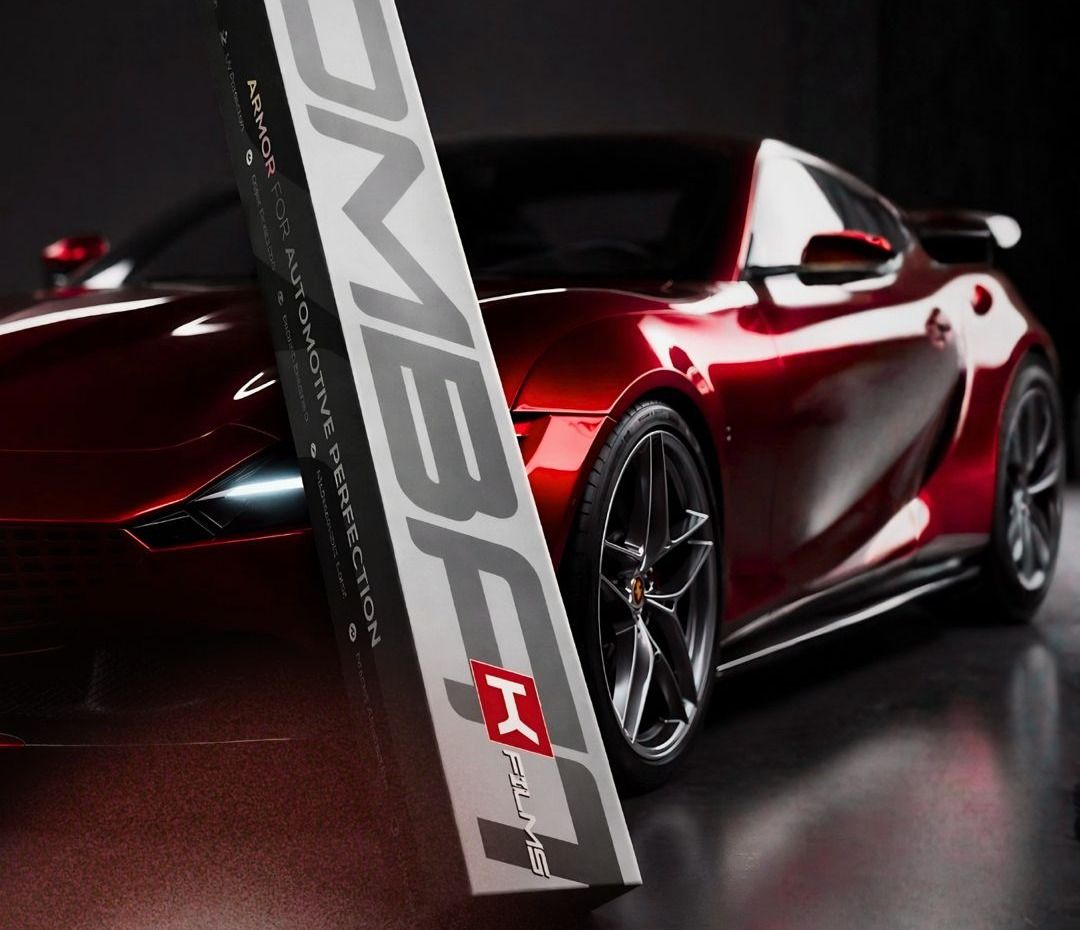 Red supercar beside a K FILMS box